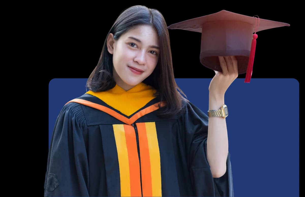 A graduate holding up her mortarboard